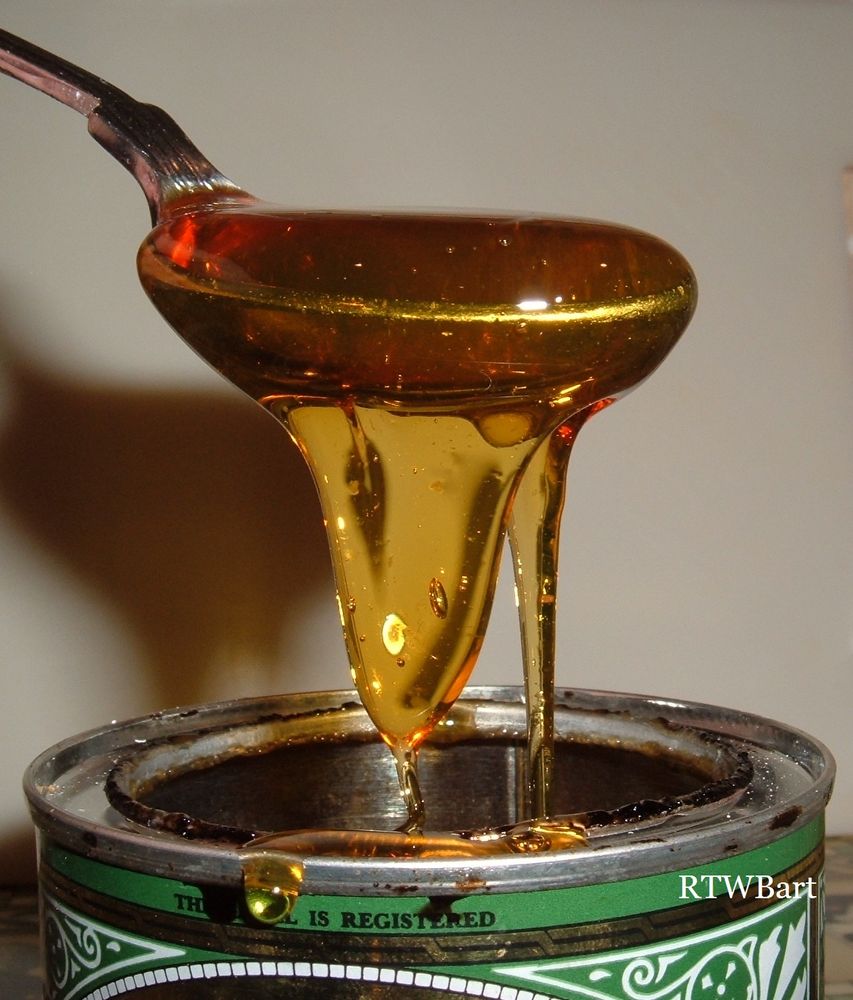 GOLDEN SYRUP DRIPPING OFF SPOON