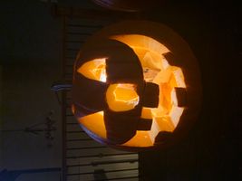 Happy and creepy carved jack o lantern with candle