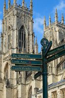 City Street Signpost with the Magnificent York Minster in the Background.