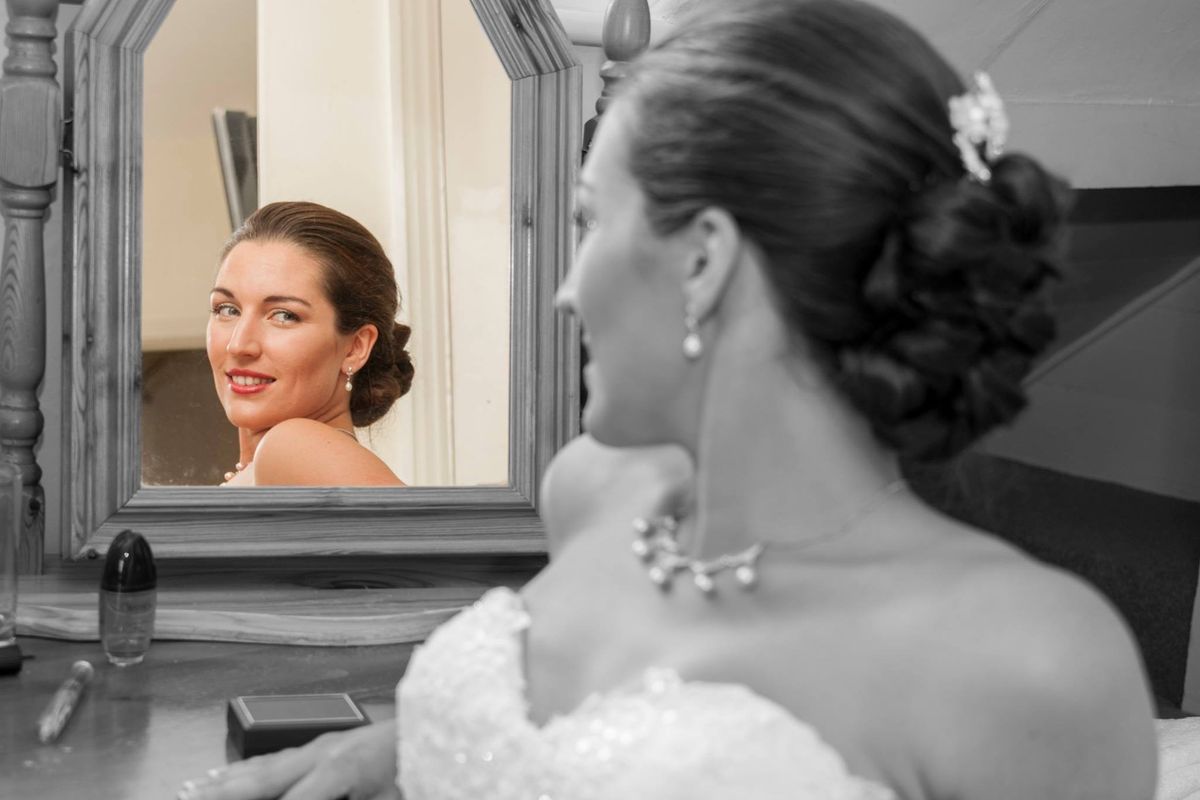A picture of the Bride in her makeup mirror before the big event.