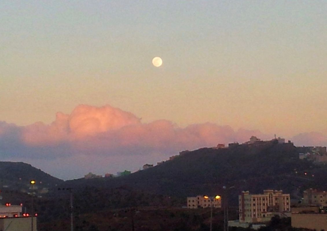 Scenery with full moon at sunset above the mountain