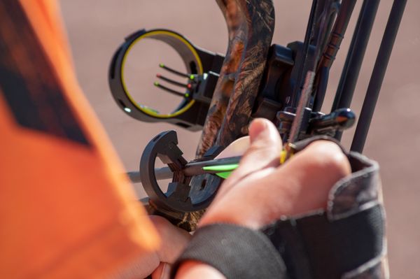 Archery Preparation - detail shot of loading and nocking arrow in compound bow at Blackwell Forest Preserve in Warrenville, Illinois - DuPage County