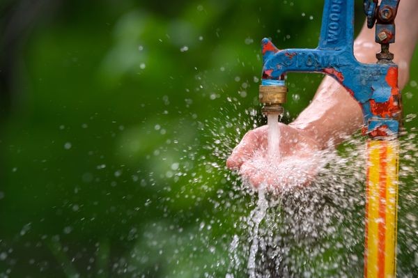 Splashing Water - Childs Hand - Water Pump