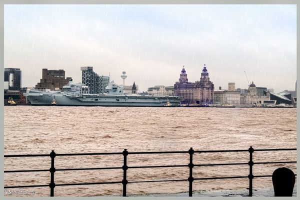 HMS Prince of Wales arrives at Liverpool Cruise Terminal in the wind and rain.