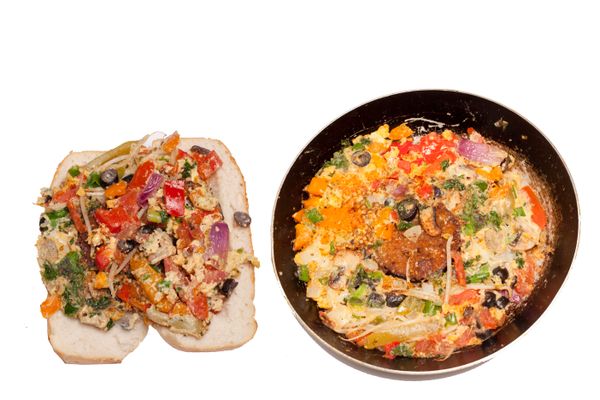 Vegetable omelet in a black iron pan On a white background